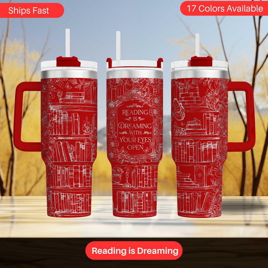 three red insulated tumblers with white text and illustrations of books, set against a blurred background of trees.