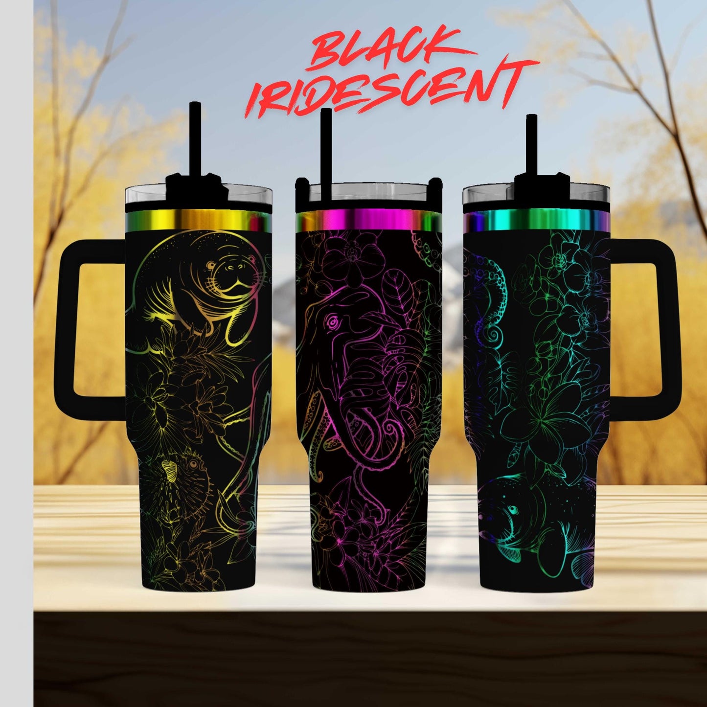 Three colorful tumblers with unique designs, including fish, flowers, and abstract patterns, are displayed against a blurred natural background.