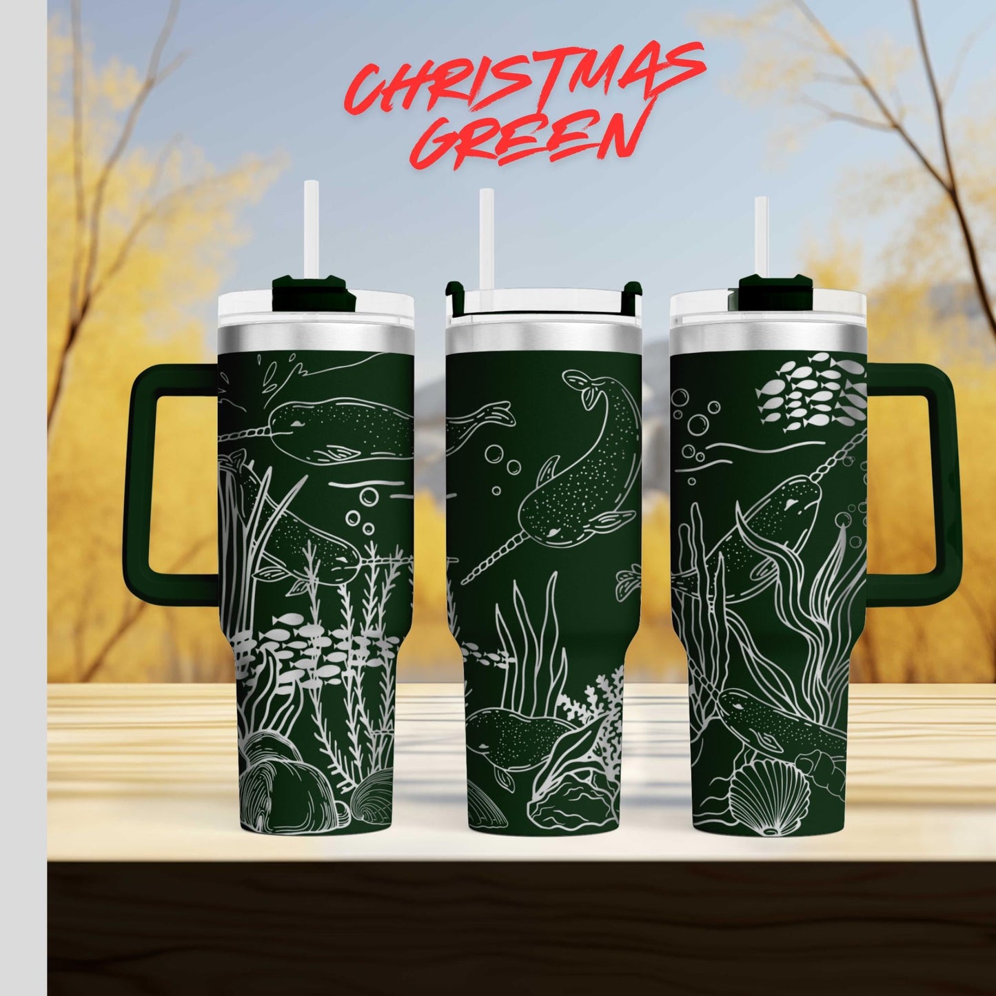 three green tumblers with white designs depicting marine life, such as fish and seaweed, against a blurred background of trees and sky.