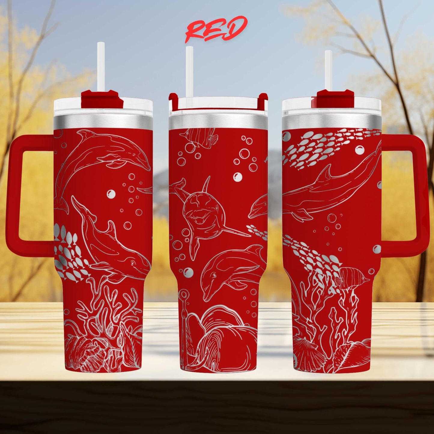 three red insulated tumblers with white illustrations of marine life, including sharks, dolphins, and bubbles, on their surfaces.