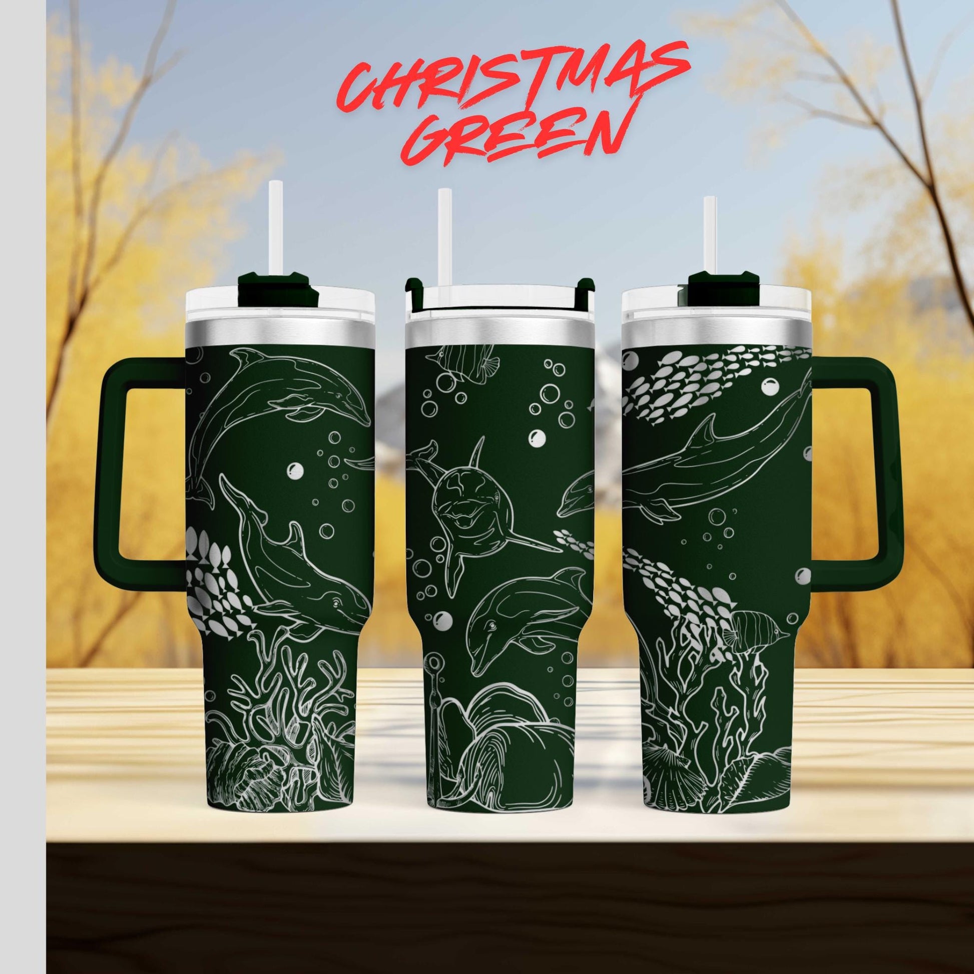 three green tumblers with white designs depicting marine life, such as dolphins and fish, on their surfaces.