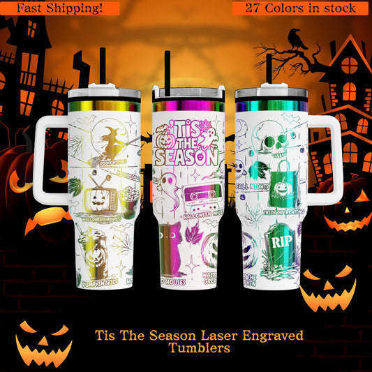 three colorful, laser-engraved tumblers with Halloween-themed designs, including skulls, pumpkins, and bats. The tumblers are described as "Tis The Season Laser Engraved Tumblers" and are available in "27 Colors in stock".