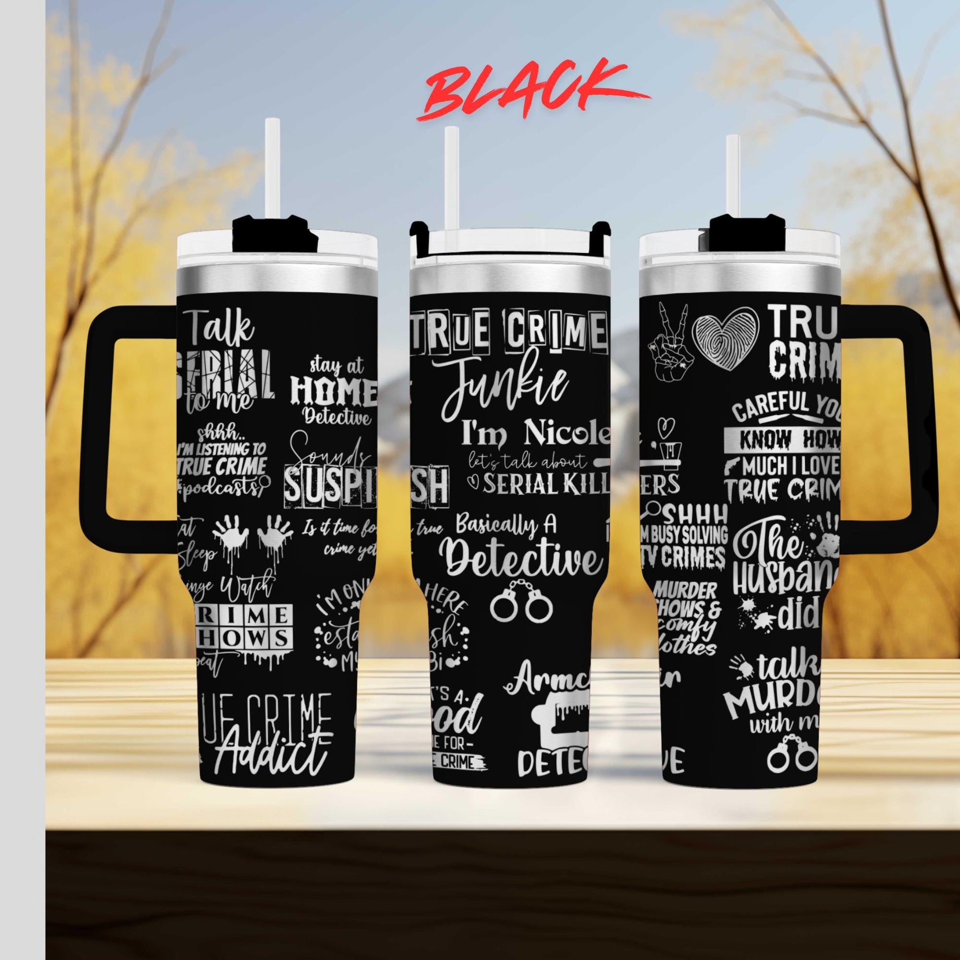 three black tumblers with white text printed on them. The text appears to be related to the TV show "True Crime", and the tumblers are placed side by side on a wooden surface.