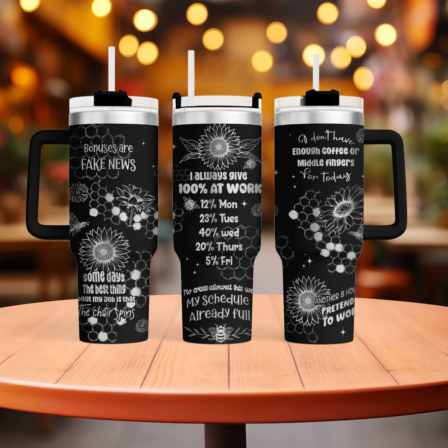 three travel mugs sitting on top of a wooden table
