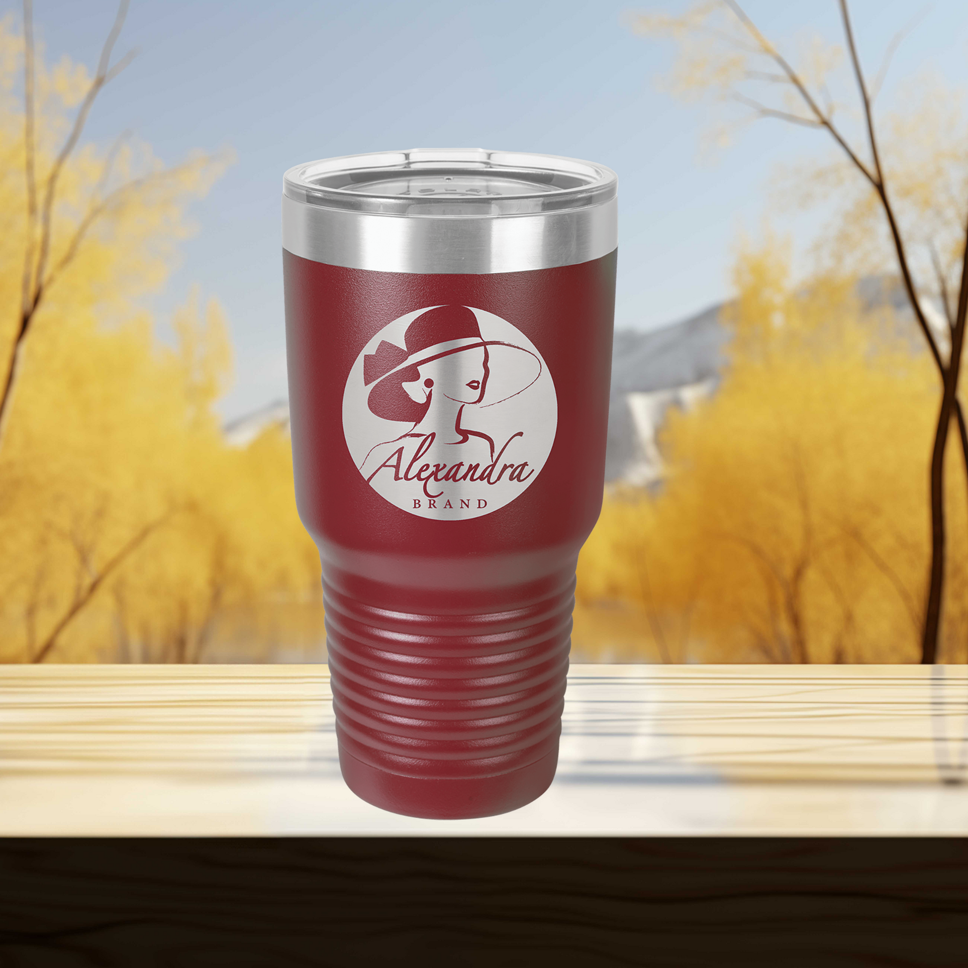 a red tumbler cup sitting on top of a wooden table