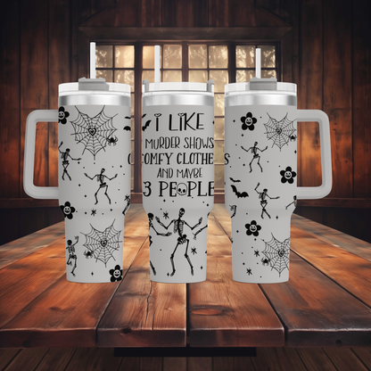 a couple of white coffee mugs sitting on top of a wooden table