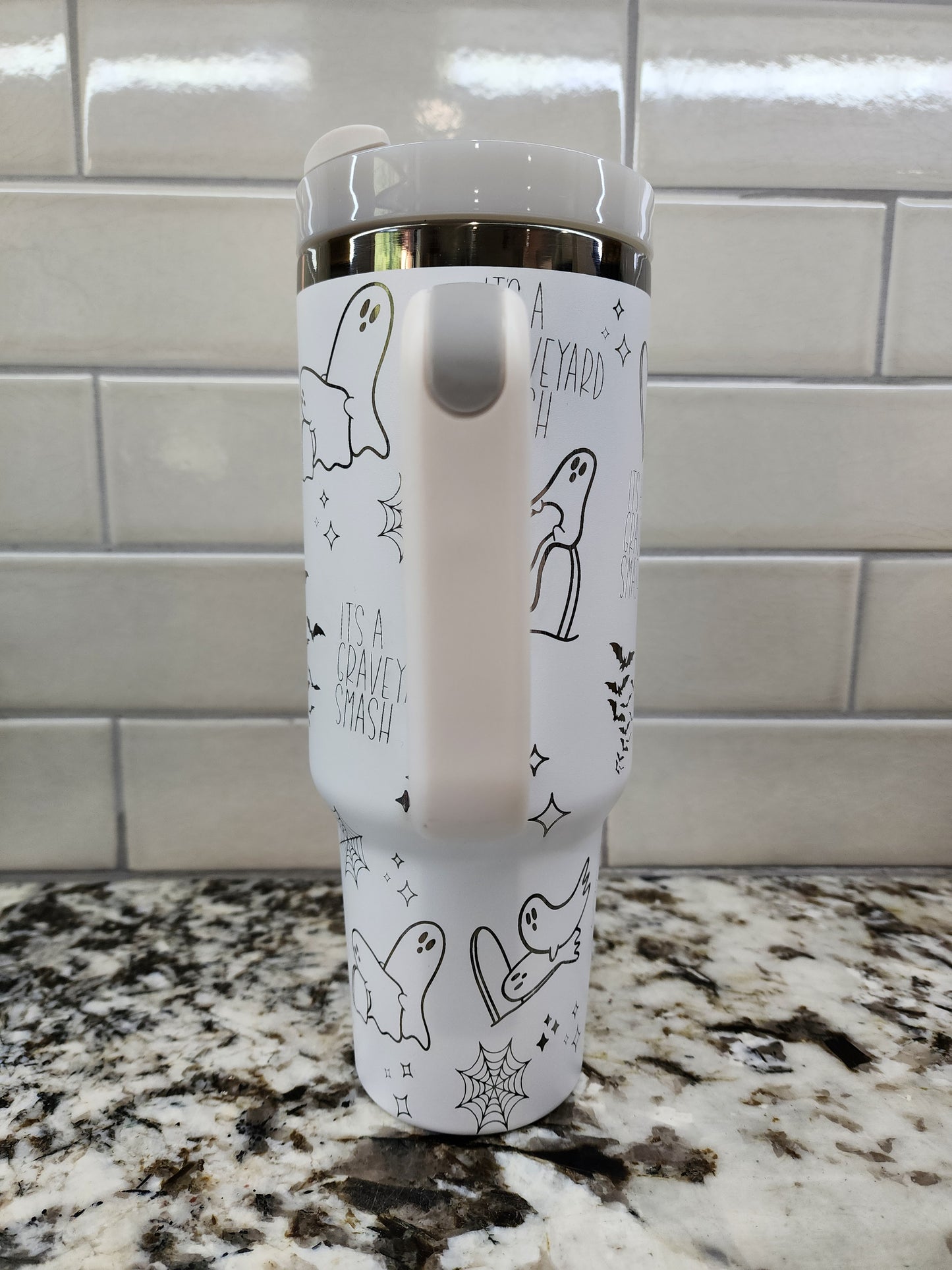 a close up of a toothbrush holder on a tiled wall