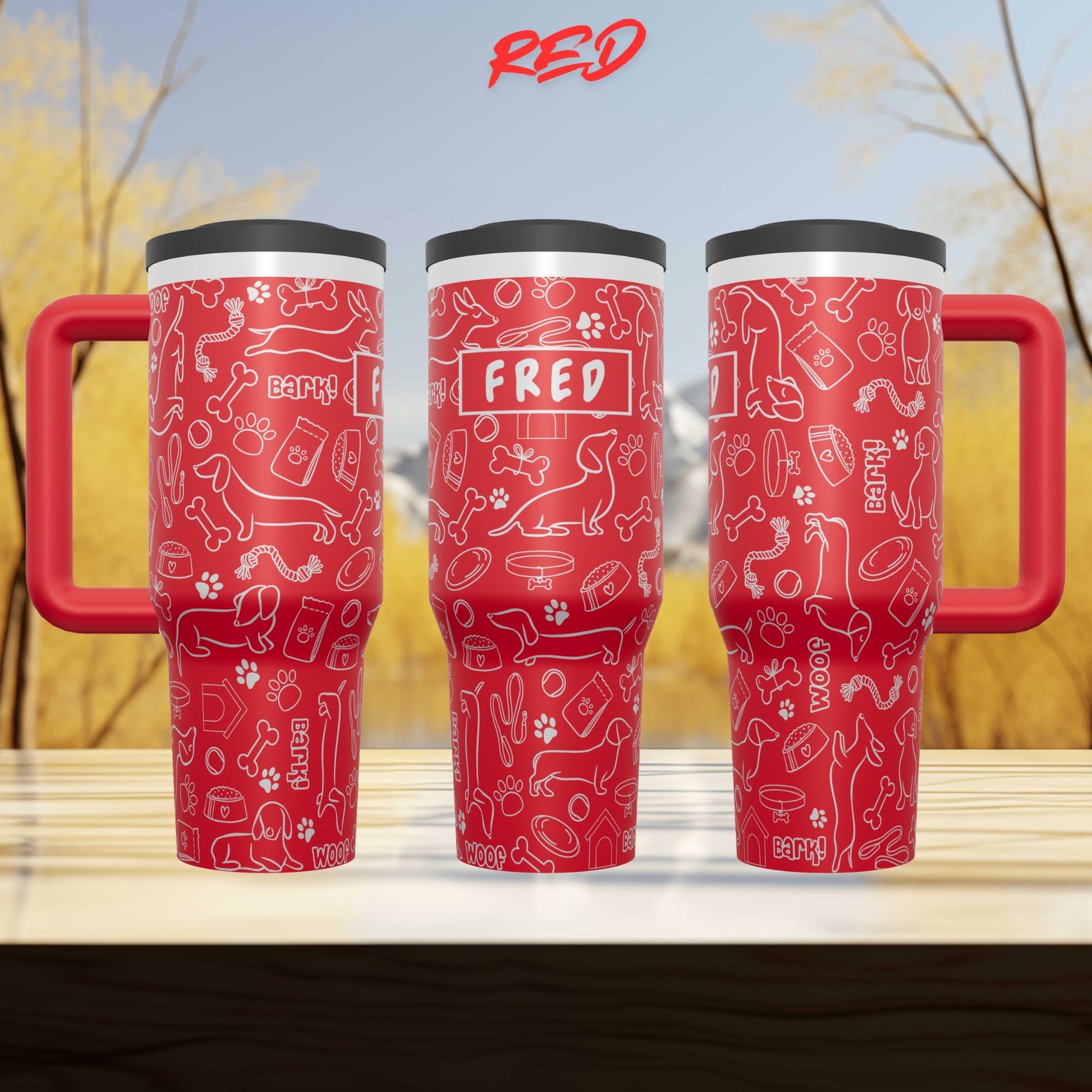 Three red travel mugs with a pattern of dog-related icons and the name "FRED" printed on them.