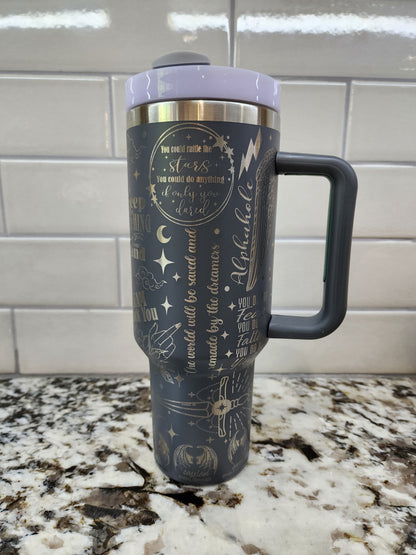 a black and gold coffee cup with a handle