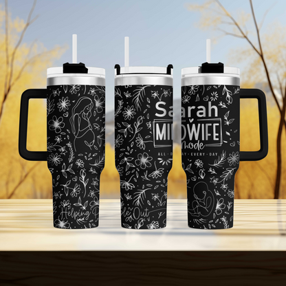 a couple of black coffee mugs sitting on top of a wooden table