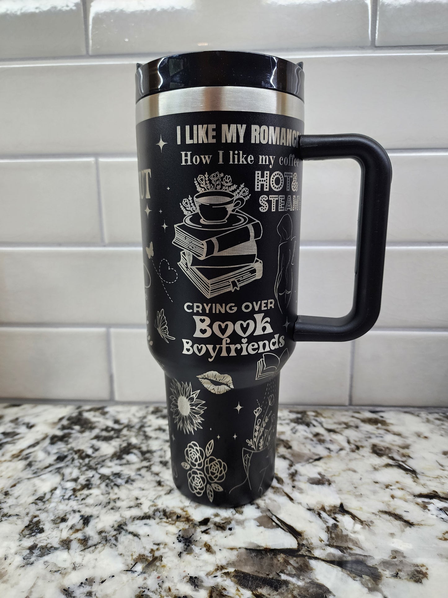 a black and white coffee cup sitting on top of a counter