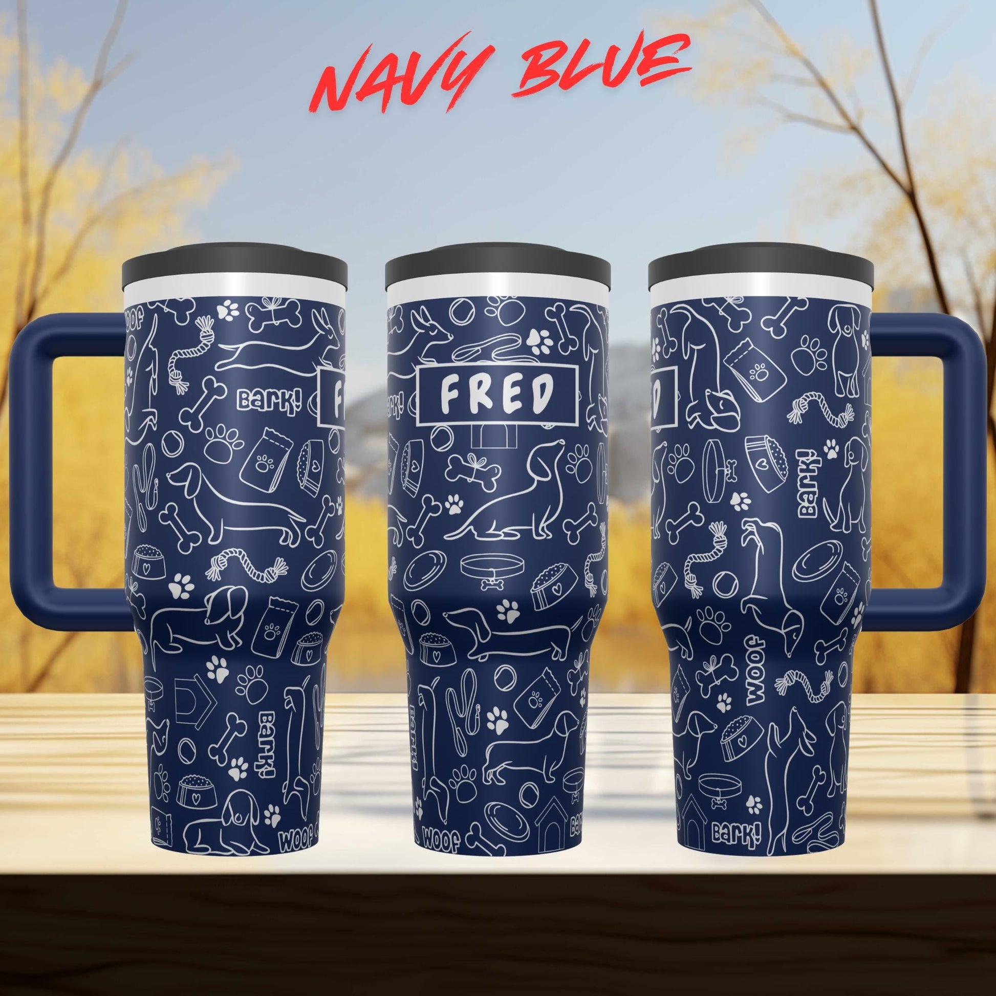 three blue tumblers with a pattern of dog-related doodles and the name "FRED" printed on them.