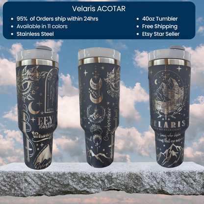 a set of three travel mugs sitting on top of a rock