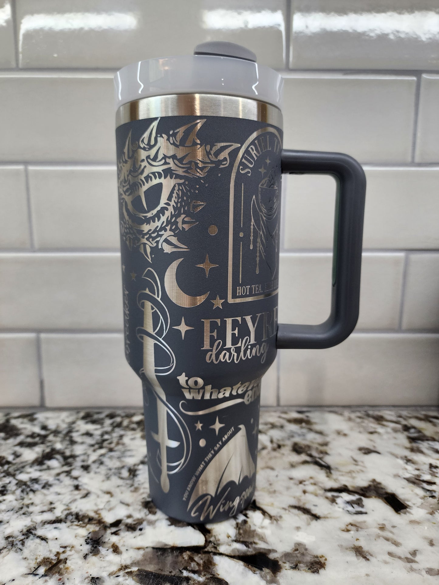 a black and gold coffee cup hanging from a hook