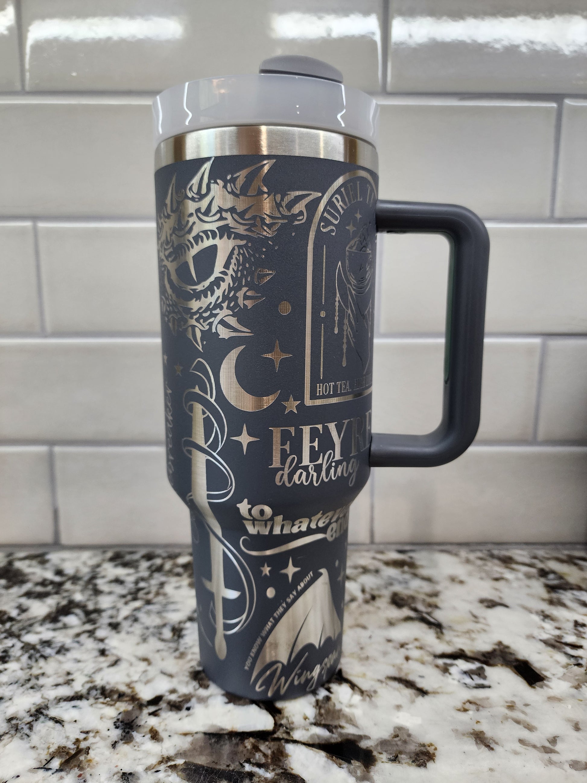 a black and gold coffee cup hanging from a hook