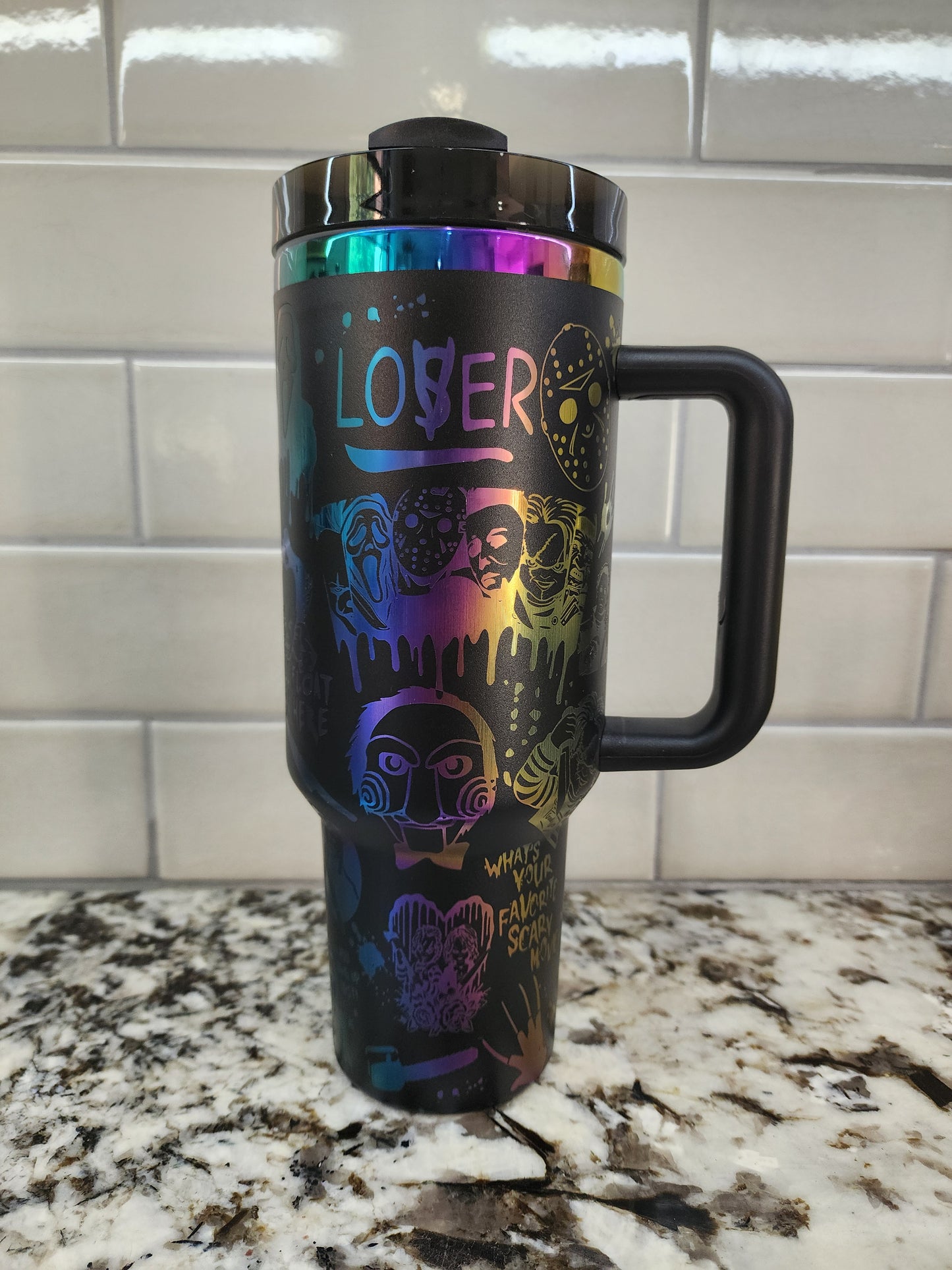 a colorful coffee cup is hanging on a hook