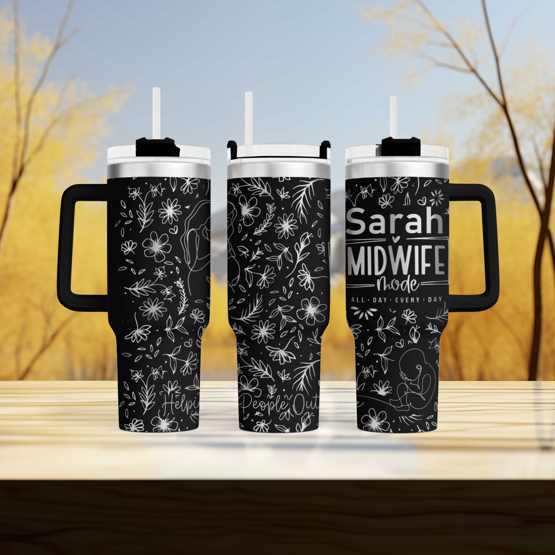 two travel mugs sitting on top of a wooden table