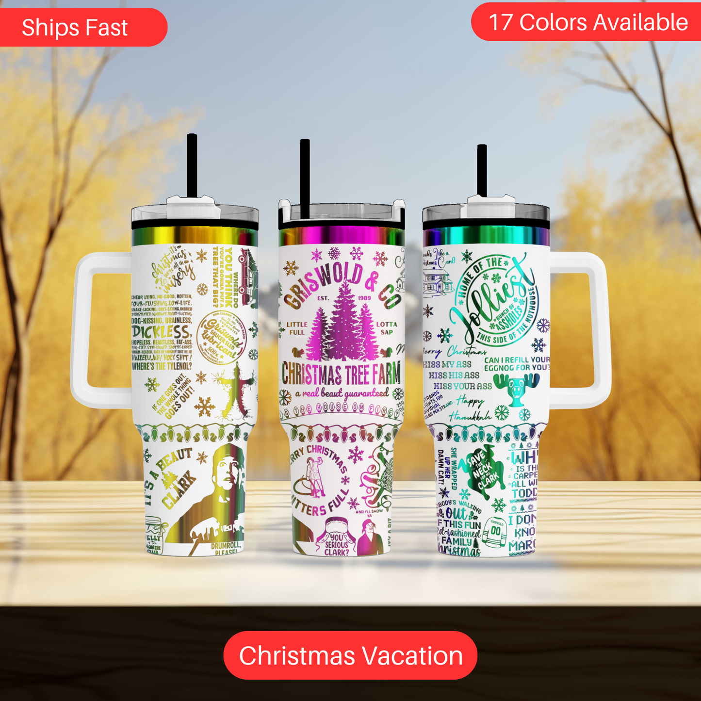 Three colorful tumblers with various designs and text, including Christmas-themed elements, are displayed on a wooden surface against a blurred background.