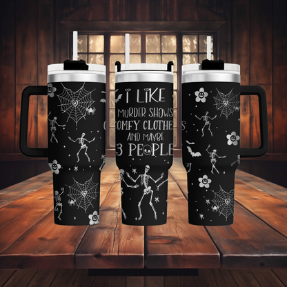 a couple of black mugs sitting on top of a wooden table