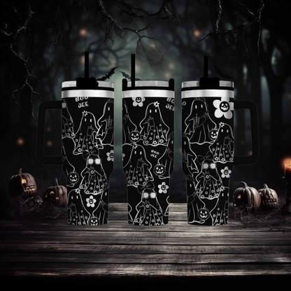a couple of black mugs sitting on top of a wooden table