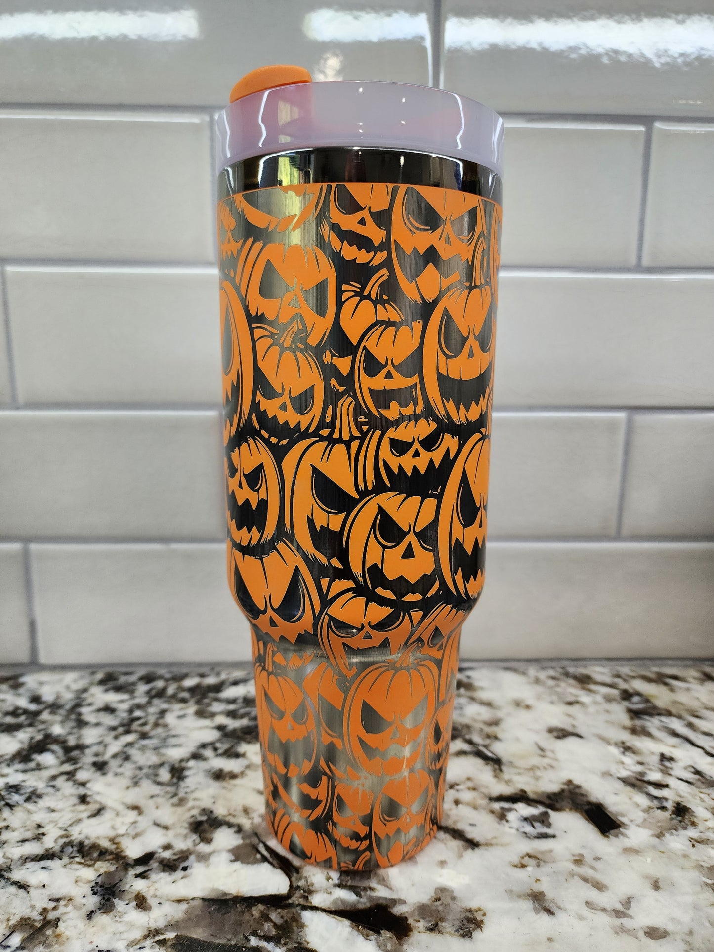 a close up of an orange and black cup