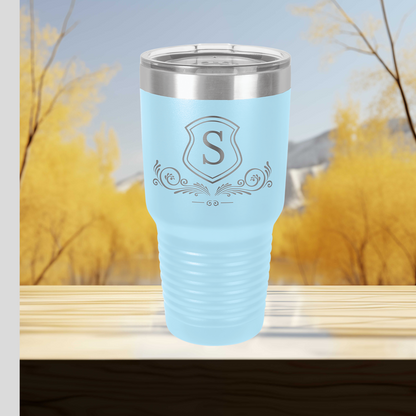 a blue tumbler cup sitting on top of a wooden table