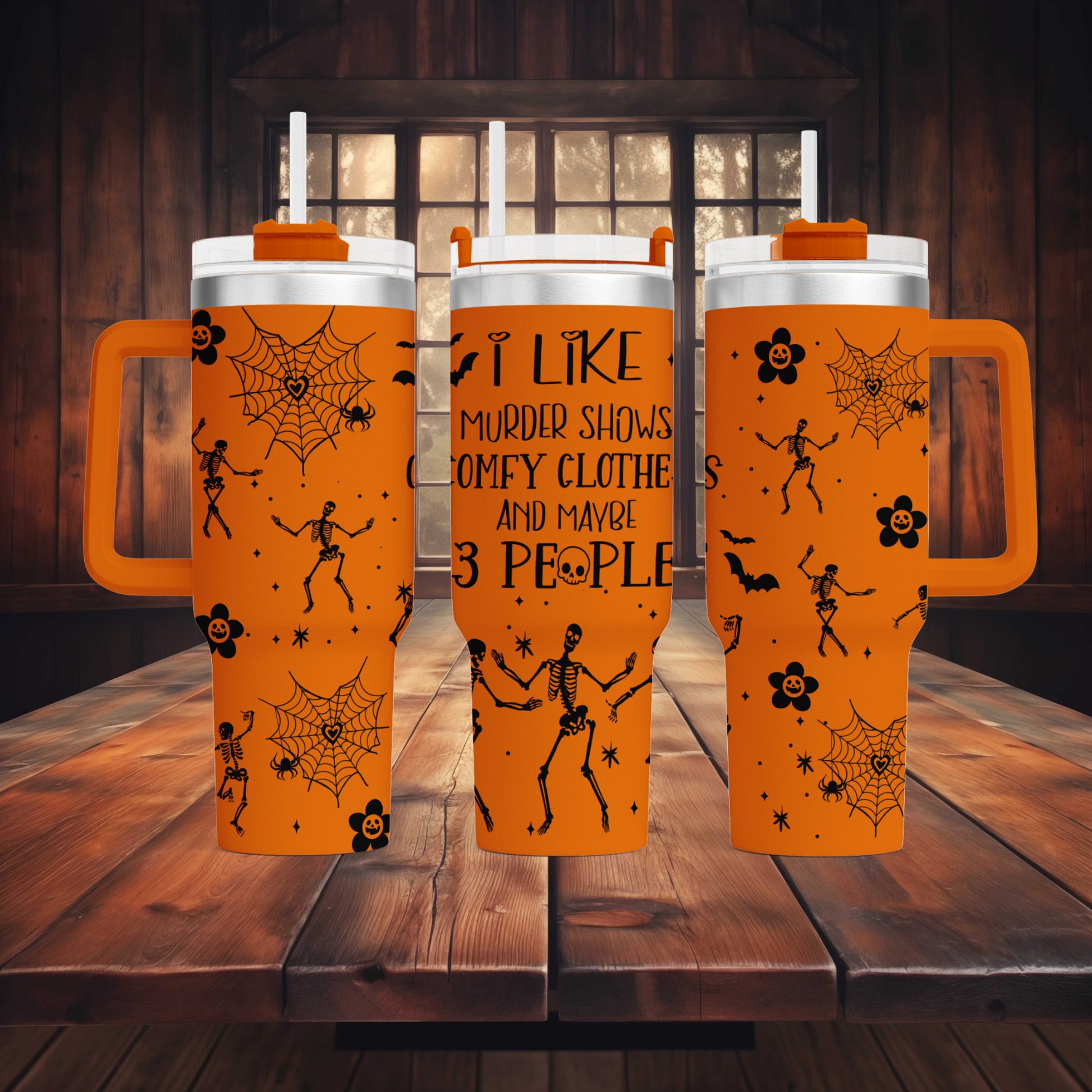 three travel mugs on a wooden table