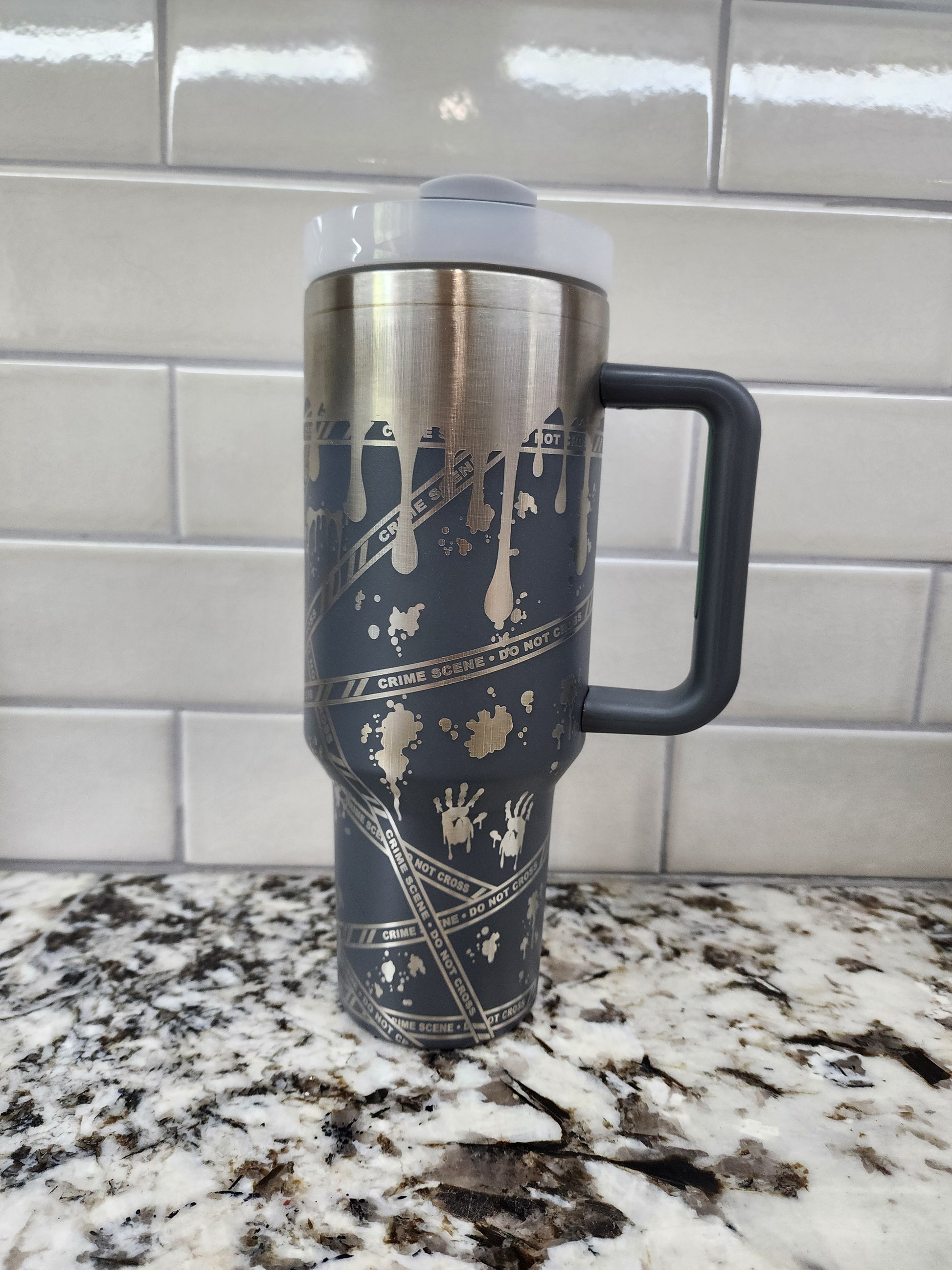 a black and gold coffee cup sitting on top of a counter