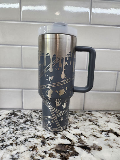 a black and gold coffee cup sitting on top of a counter