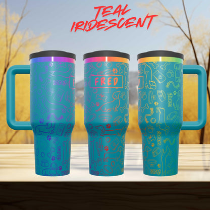 three colorful teal-colored mugs with various designs and text on them, placed on a wooden surface against a blurred background of trees.