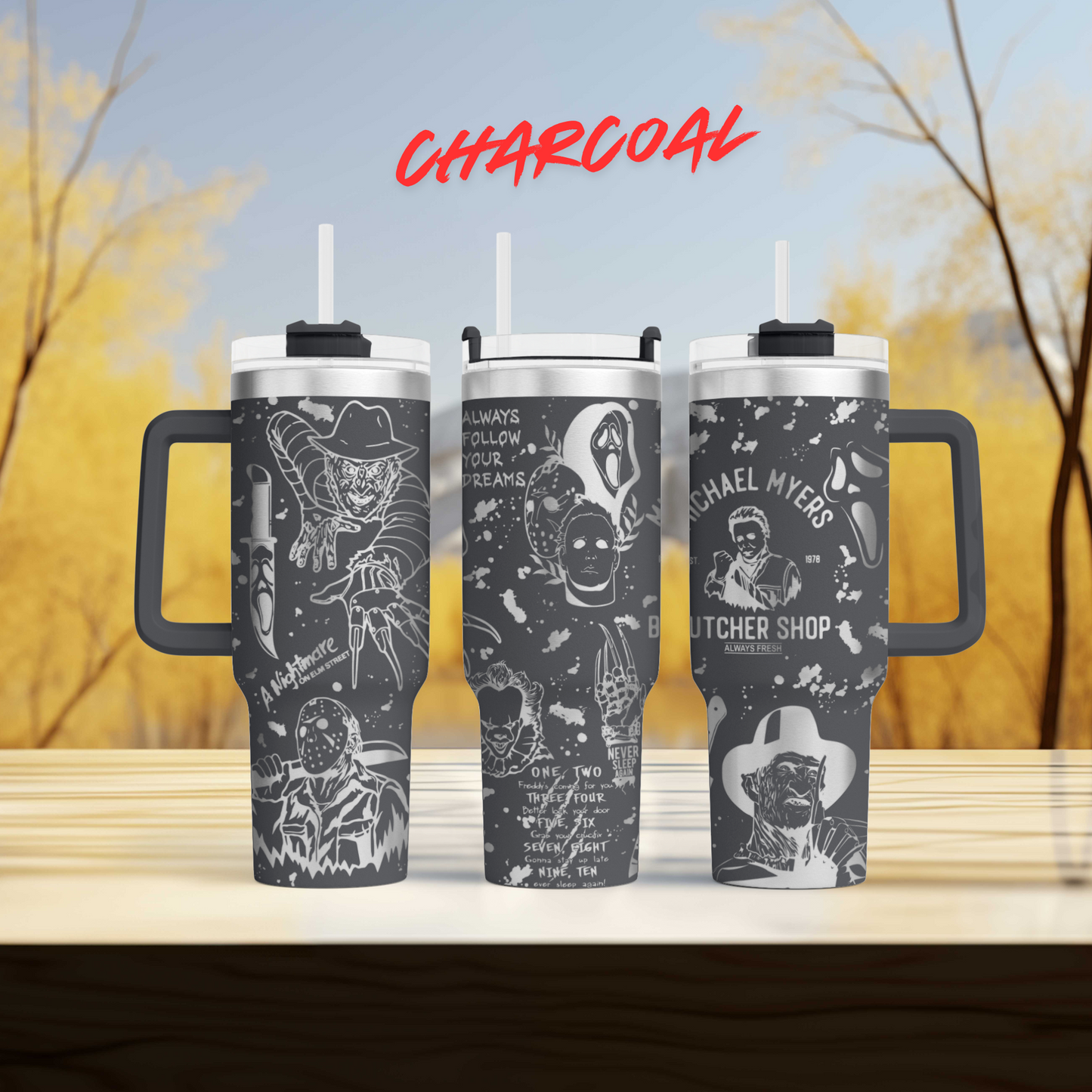 three travel mugs sitting on top of a wooden table