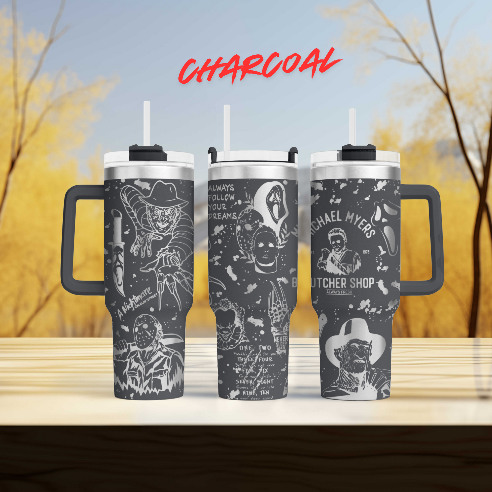 three travel mugs sitting on top of a wooden table