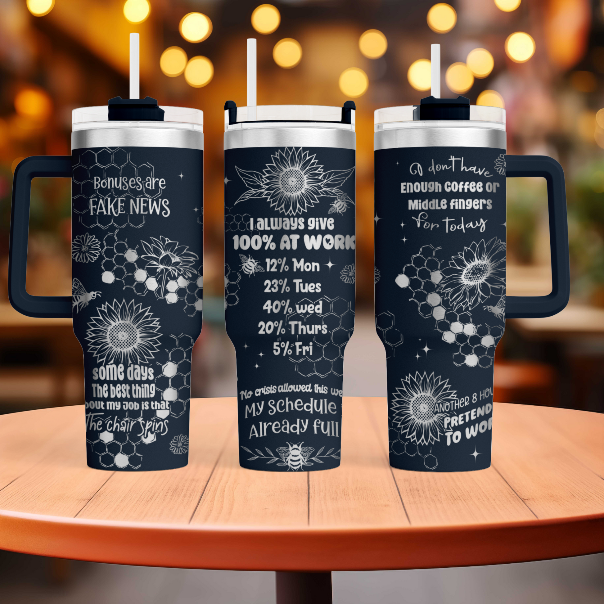 three travel mugs sitting on top of a wooden table