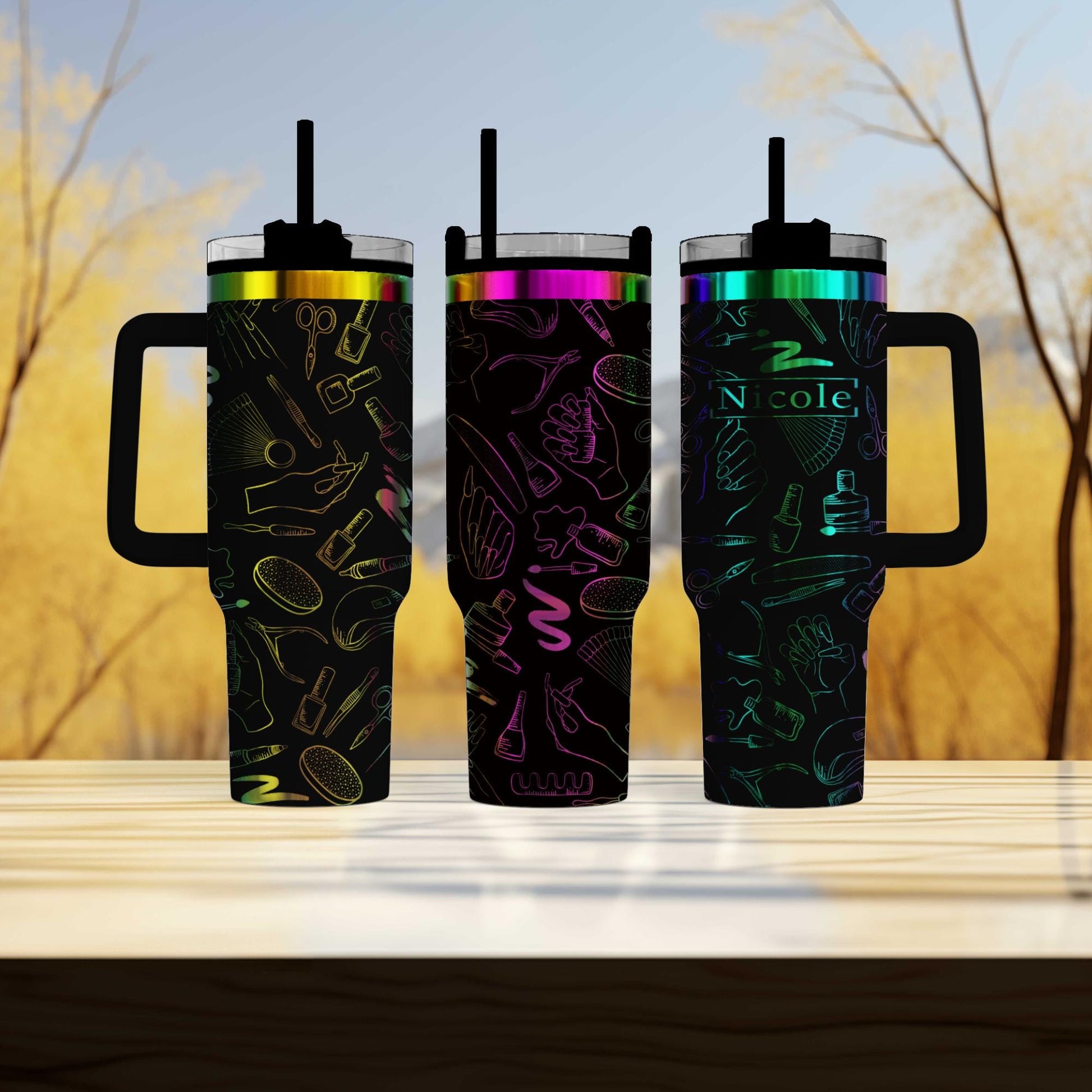 three travel mugs sitting on a table with trees in the background