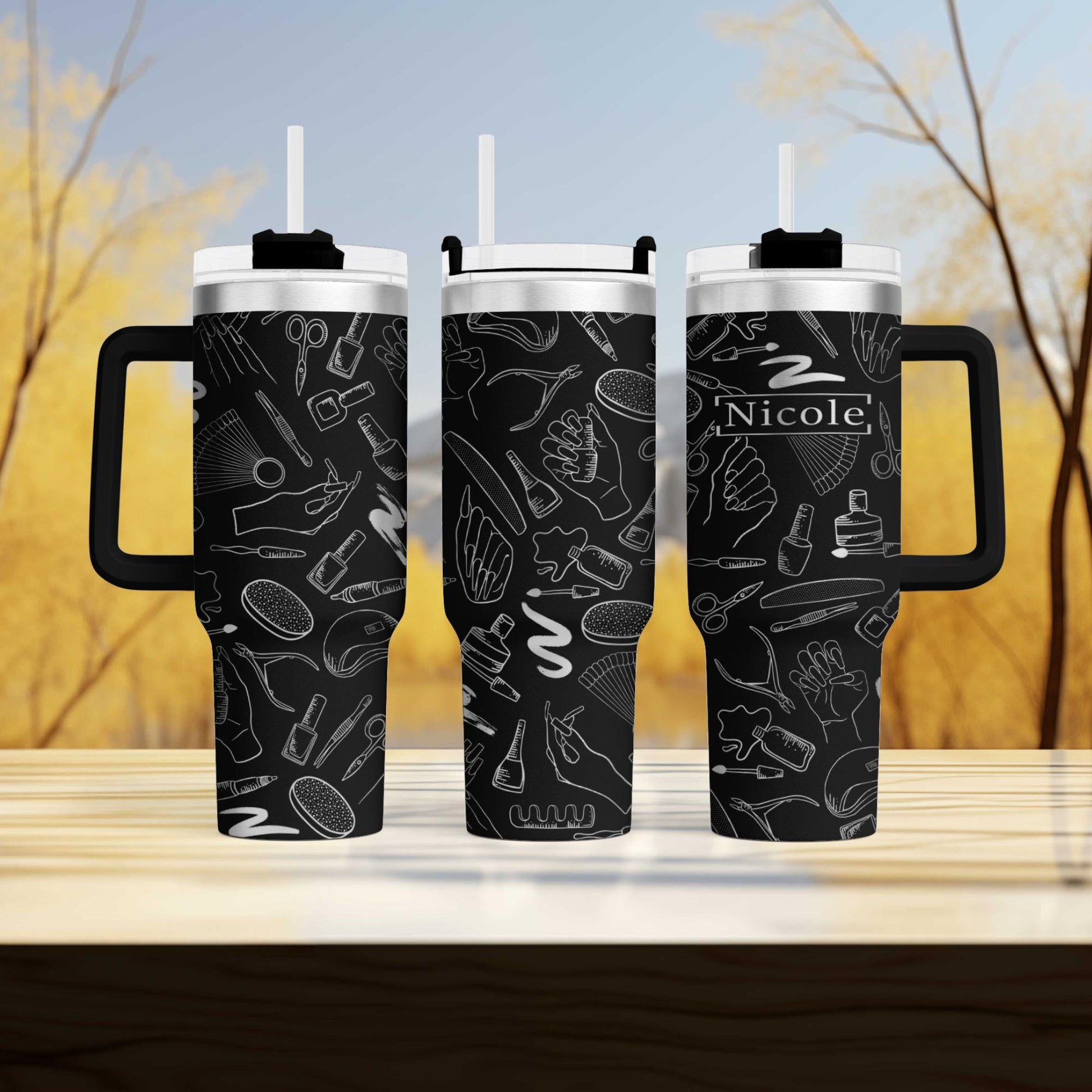 a couple of black coffee mugs sitting on top of a wooden table