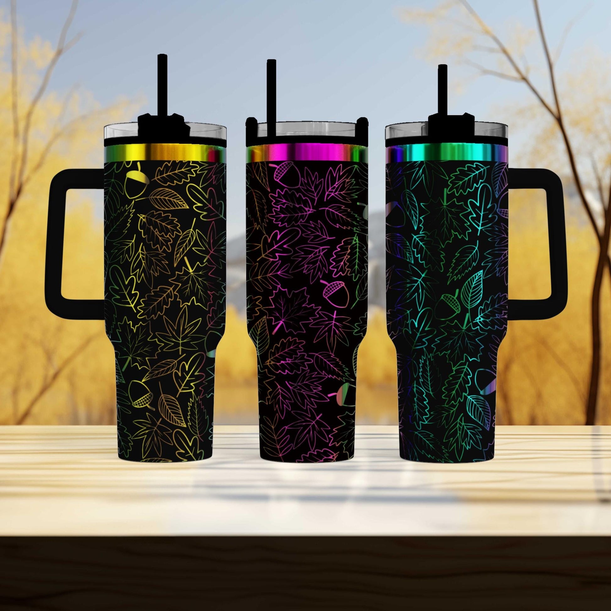 three travel mugs sitting next to each other on a table