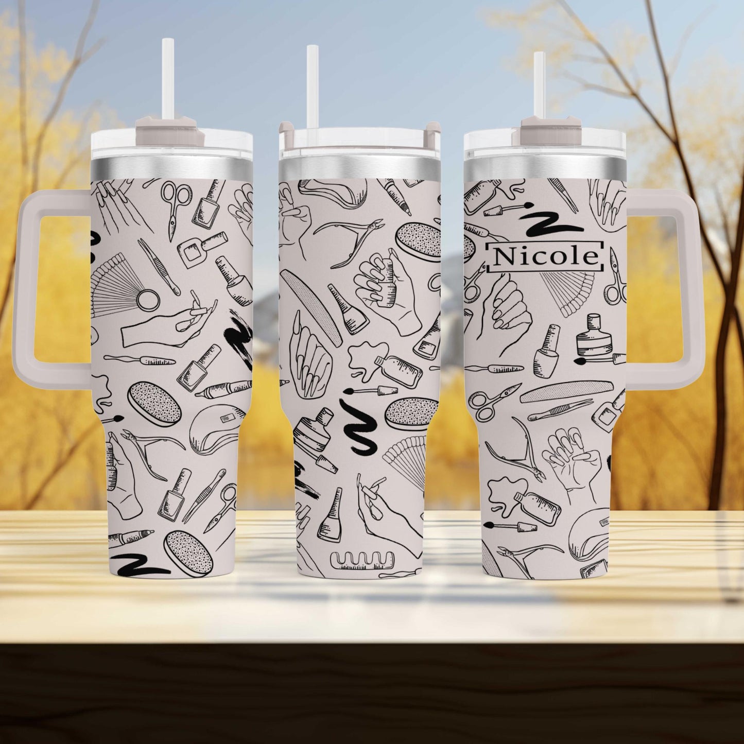three travel mugs sitting on top of a wooden table