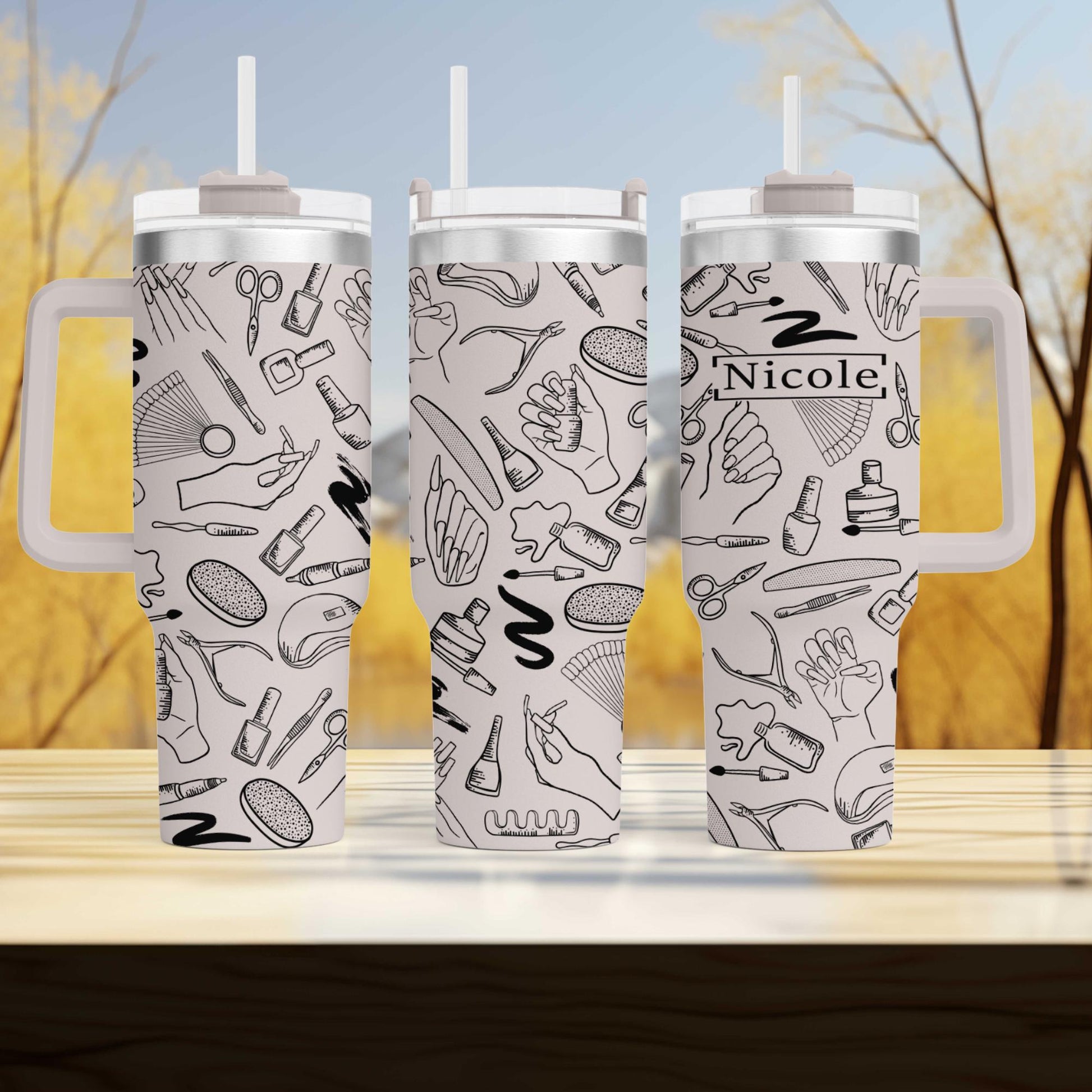 three travel mugs sitting on top of a wooden table
