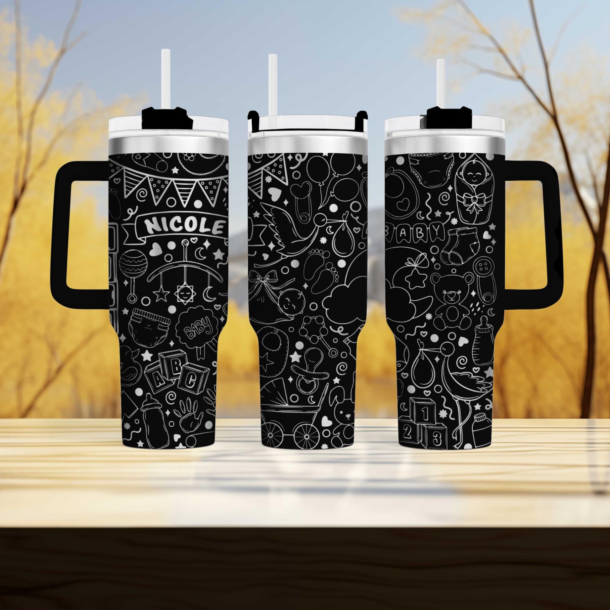 a couple of black coffee mugs sitting on top of a wooden table