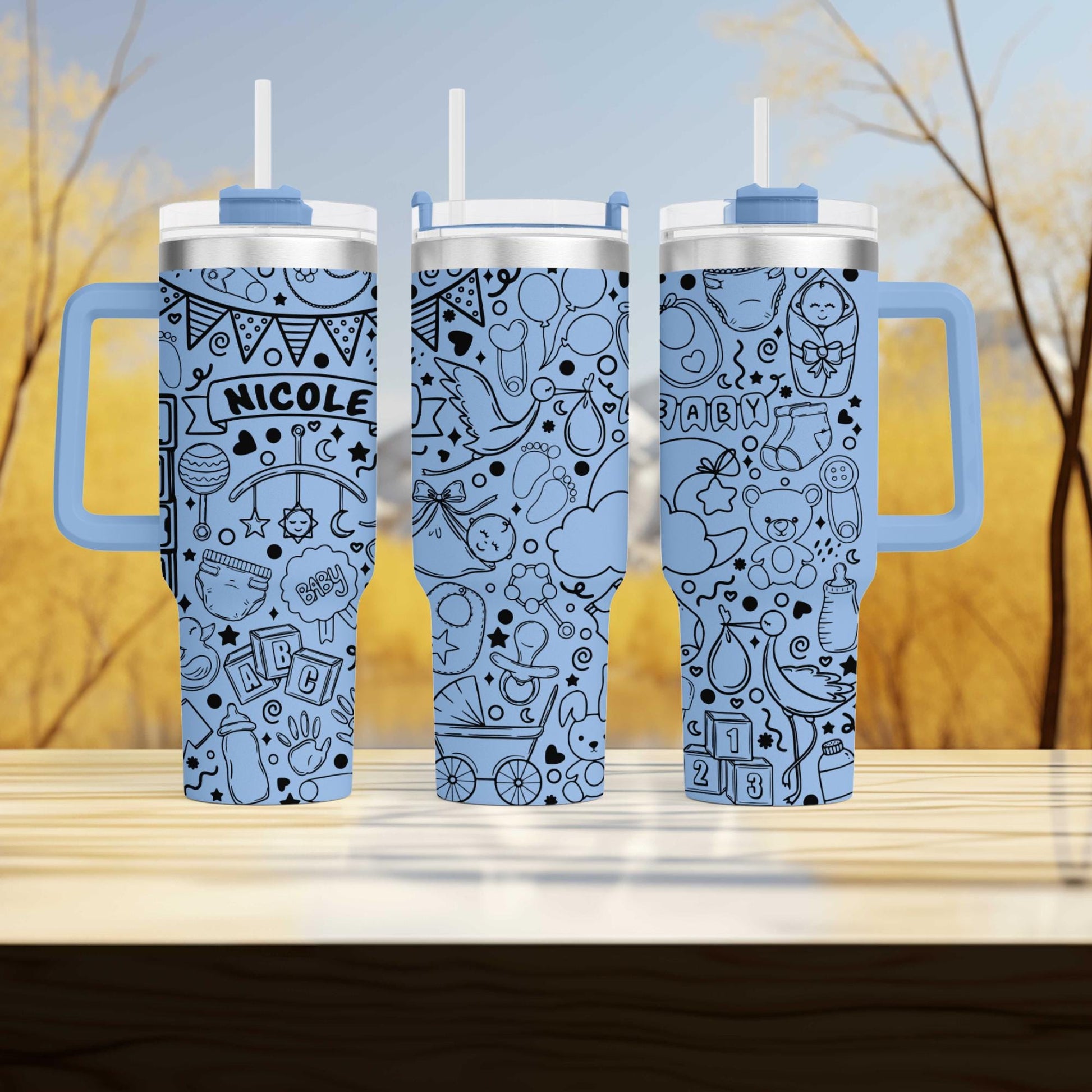 three travel mugs sitting on top of a wooden table