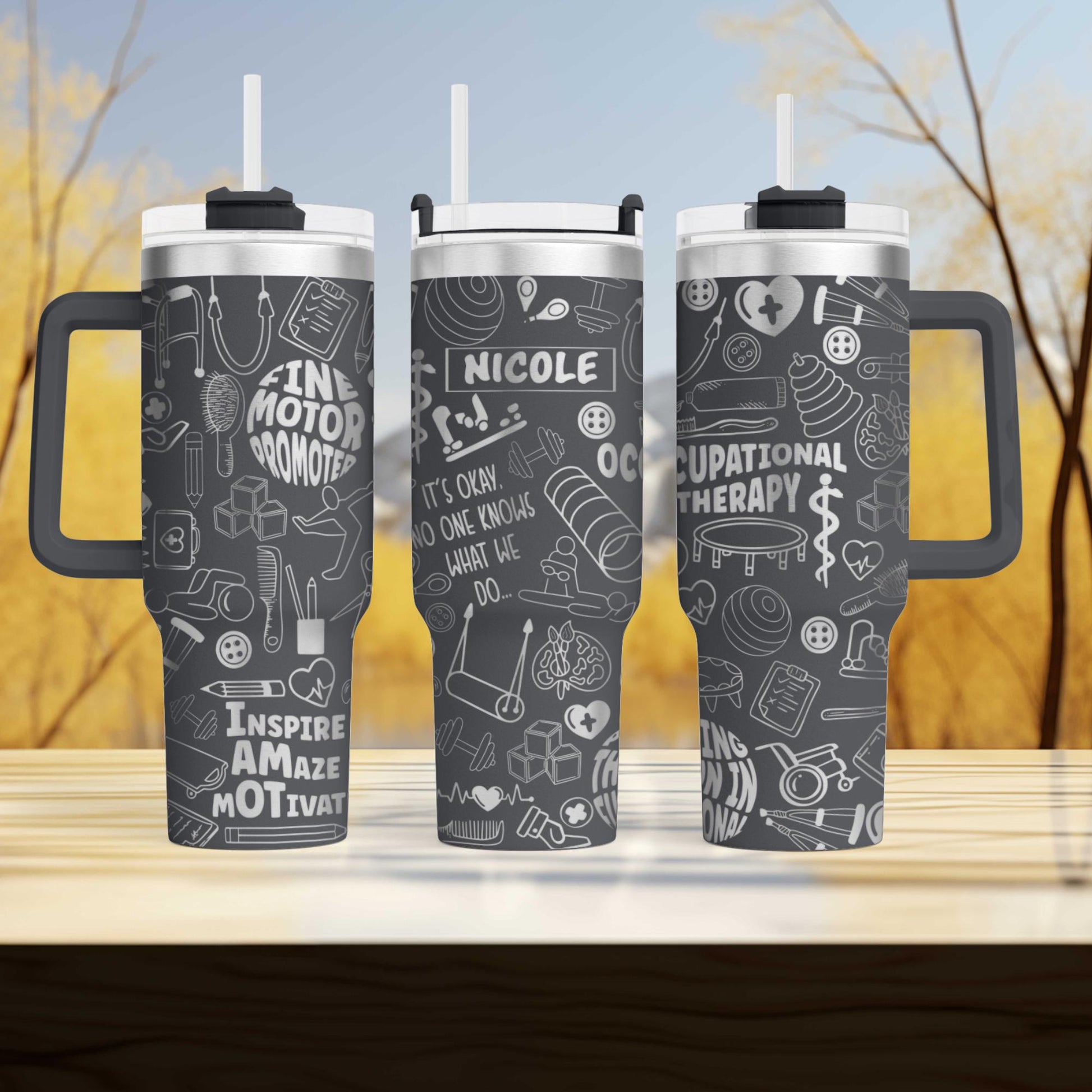 three travel mugs sitting on top of a wooden table