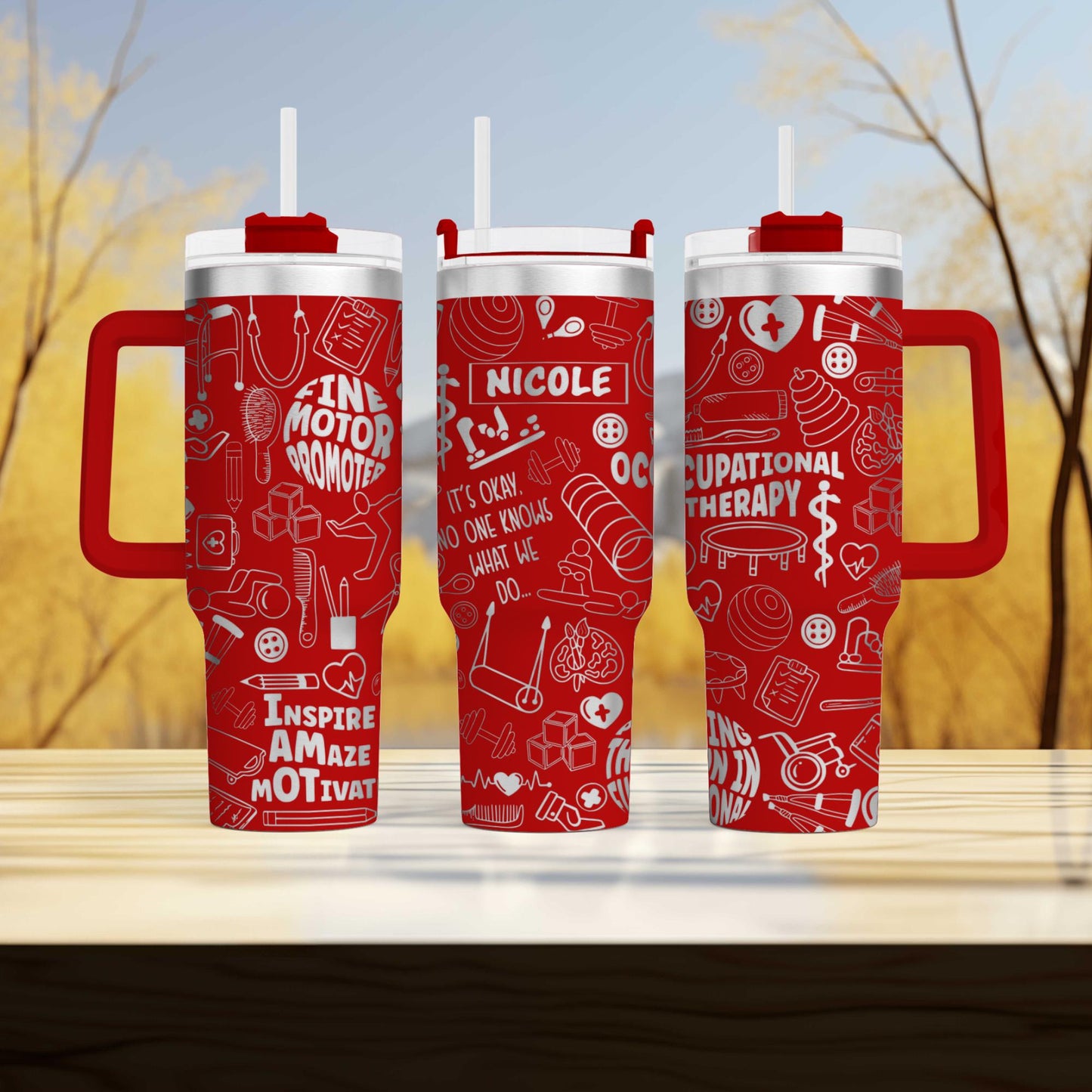three red travel mugs sitting on top of a wooden table
