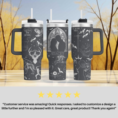 a couple of travel mugs sitting on top of a table