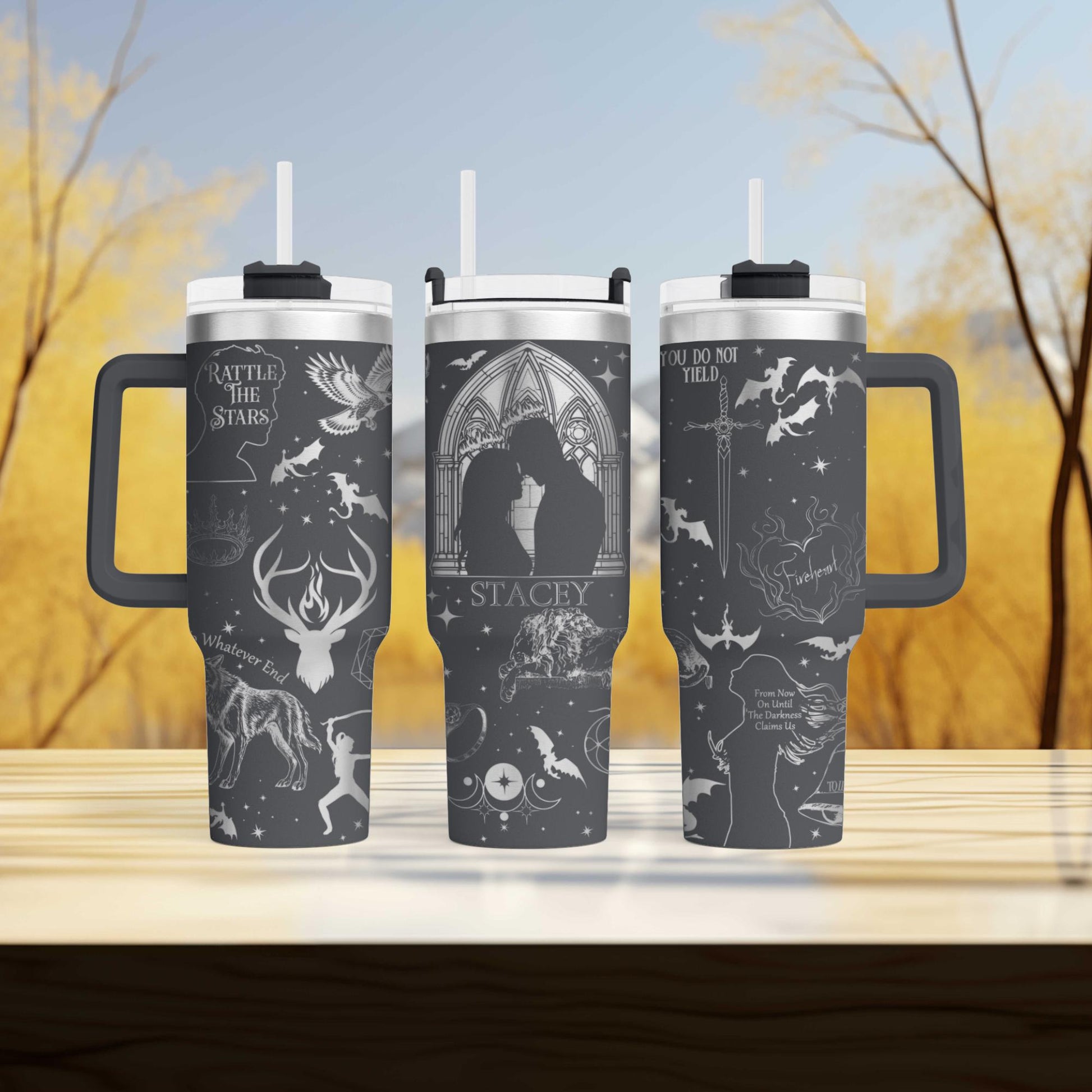 a couple of travel mugs sitting on top of a table