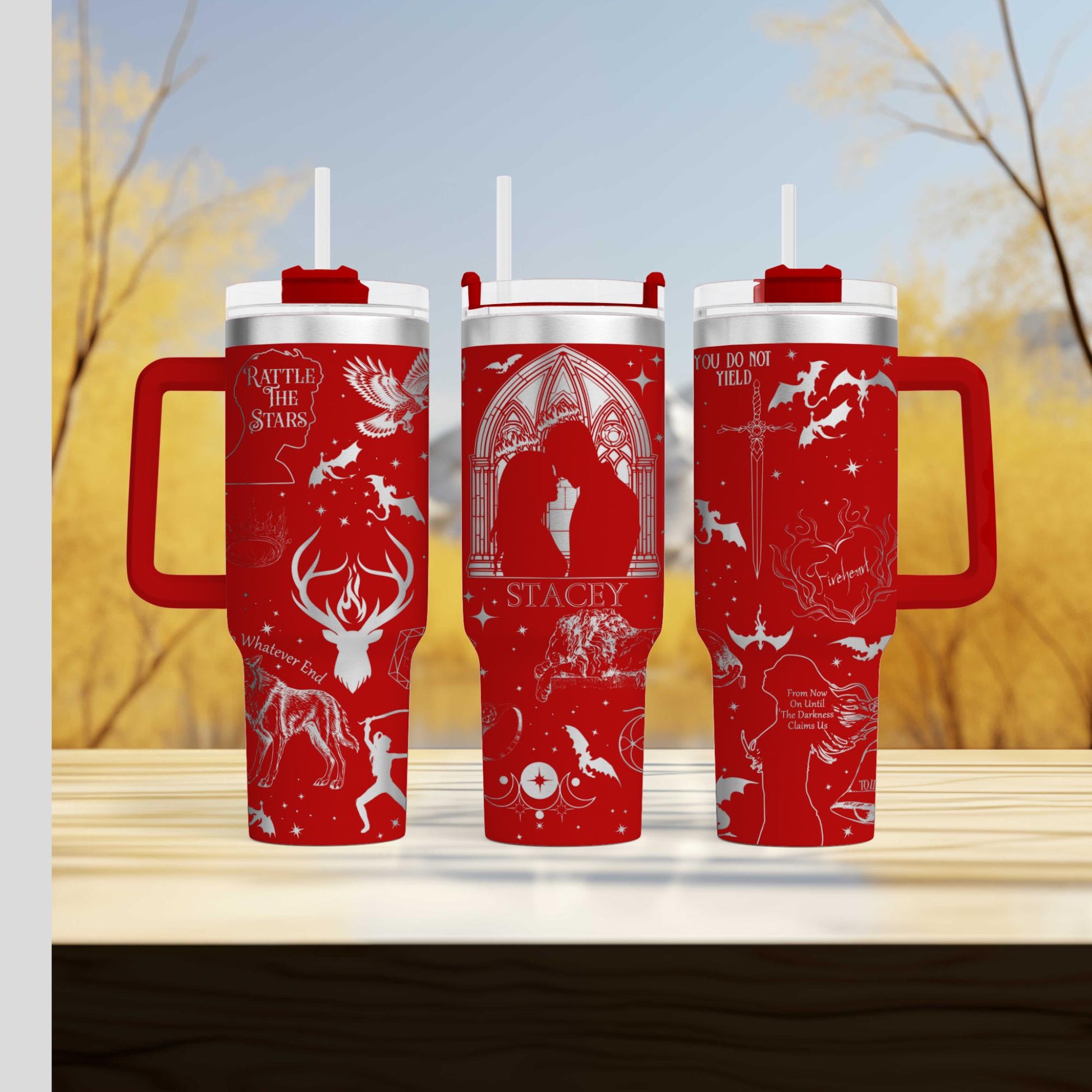 three red travel mugs sitting on top of a wooden table
