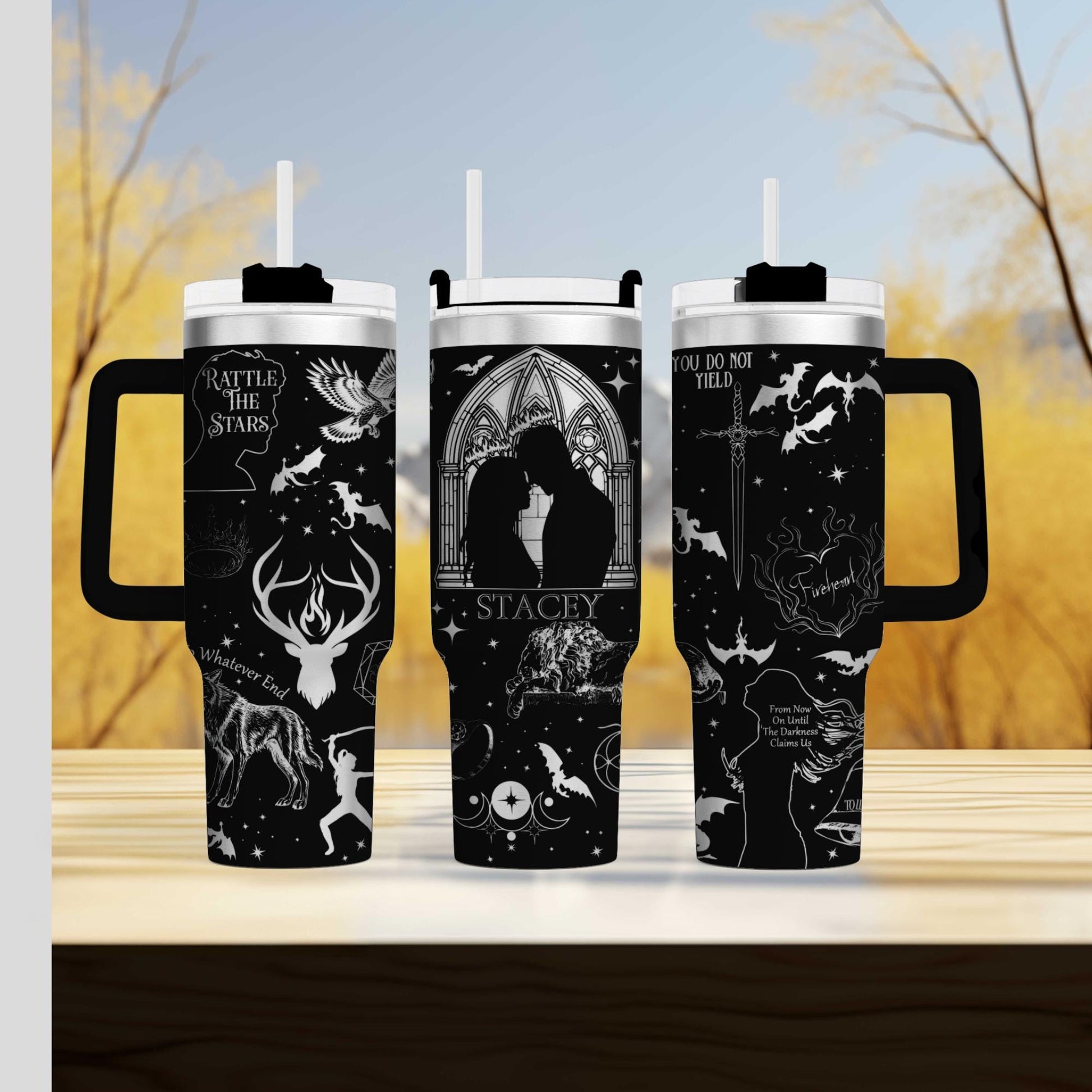 three travel mugs sitting on top of a wooden table