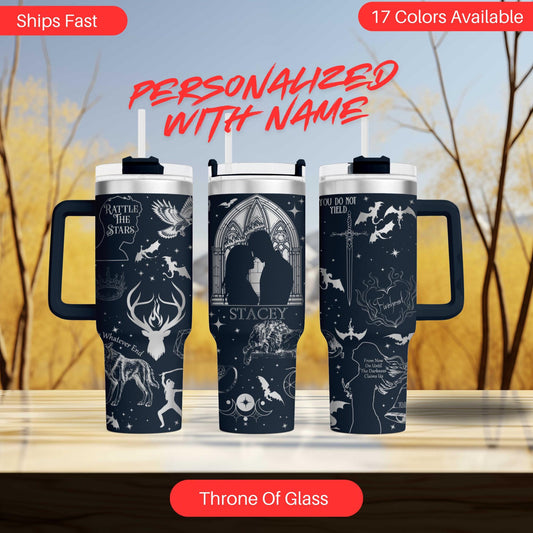 a couple of travel mugs sitting on top of a table