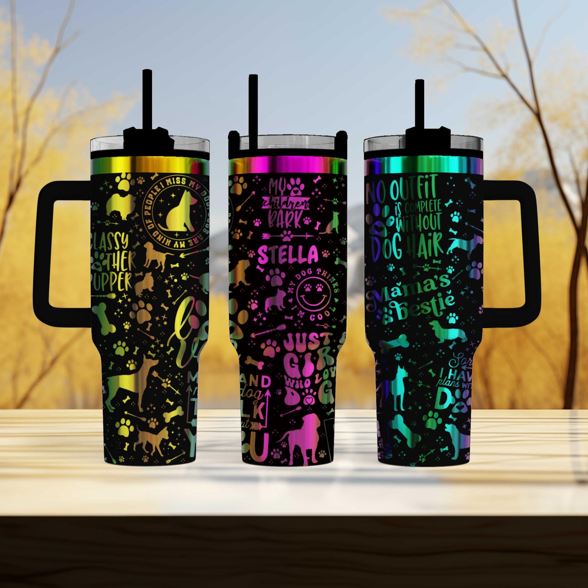 three colorful tumblers sitting on top of a wooden table