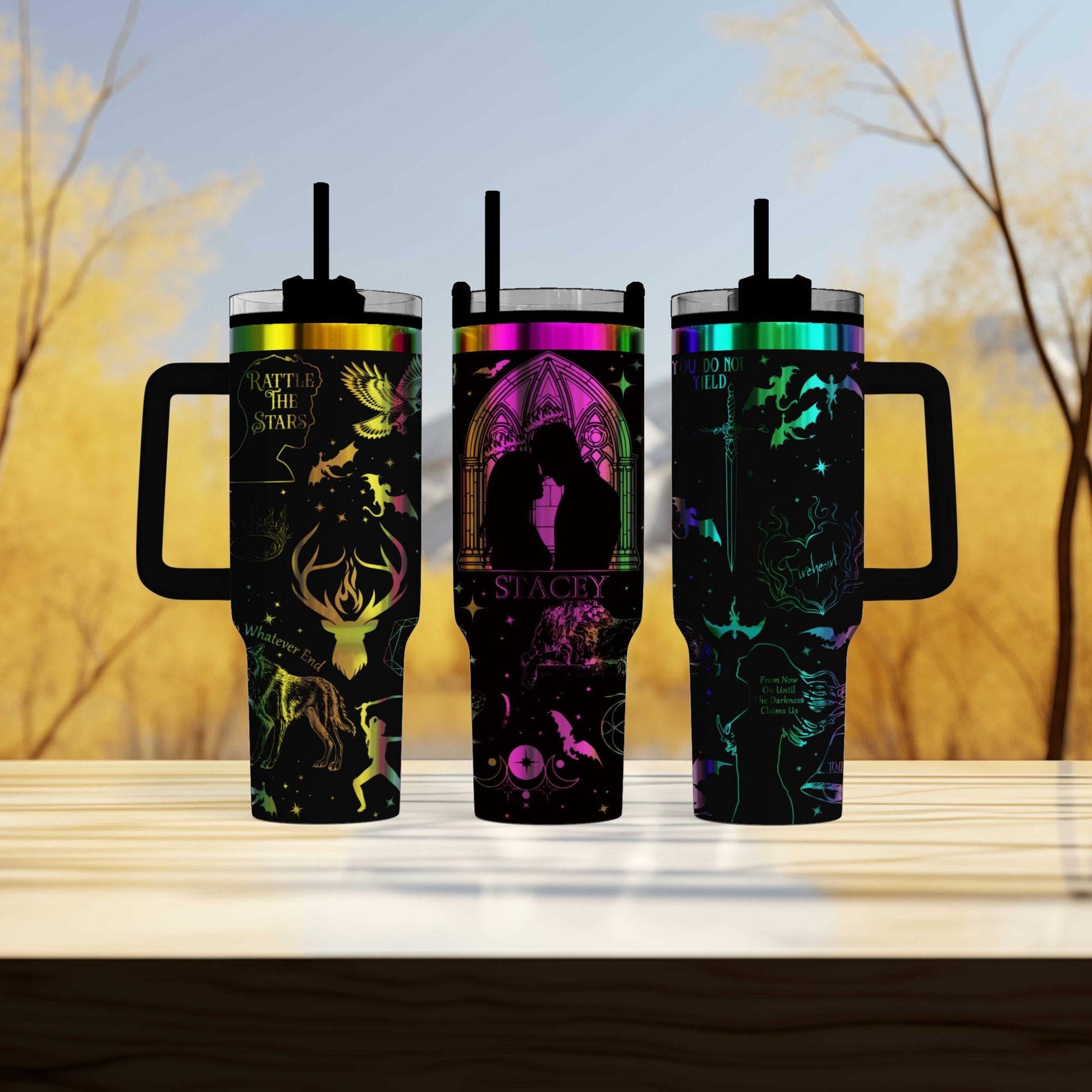 three travel mugs sitting on top of a wooden table