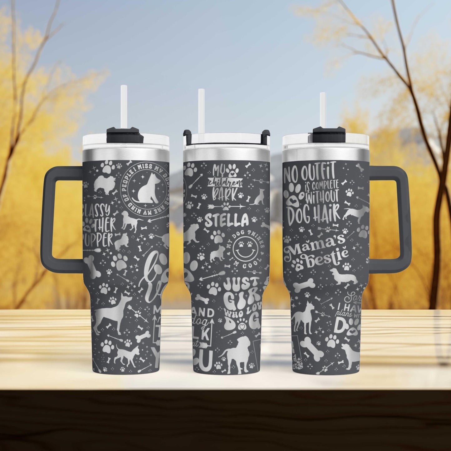 three travel mugs sitting on top of a wooden table